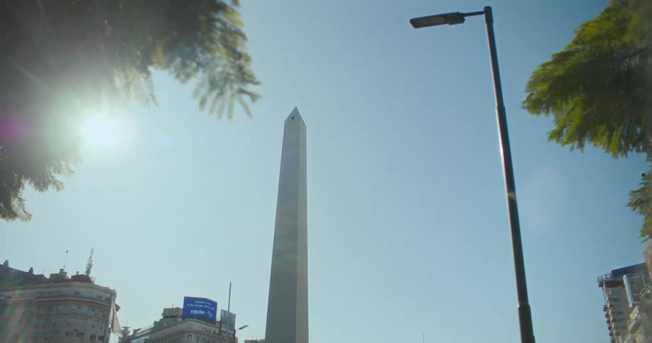 A large white obelisk with a thin tip in contrast to the blue sky