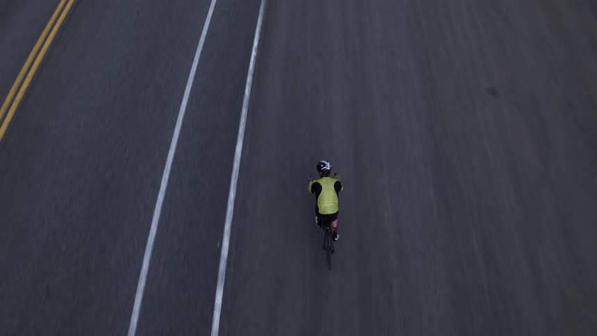 Aerial view of a cyclist riding along a highway