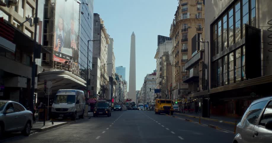 A city street leading to an obelisk