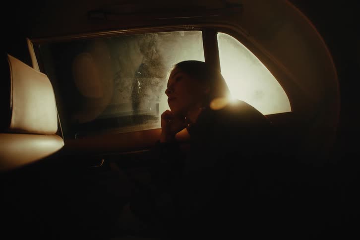 Woman sitting in the back seat of a car