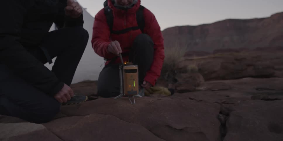 Person lighting a lantern at their campsite