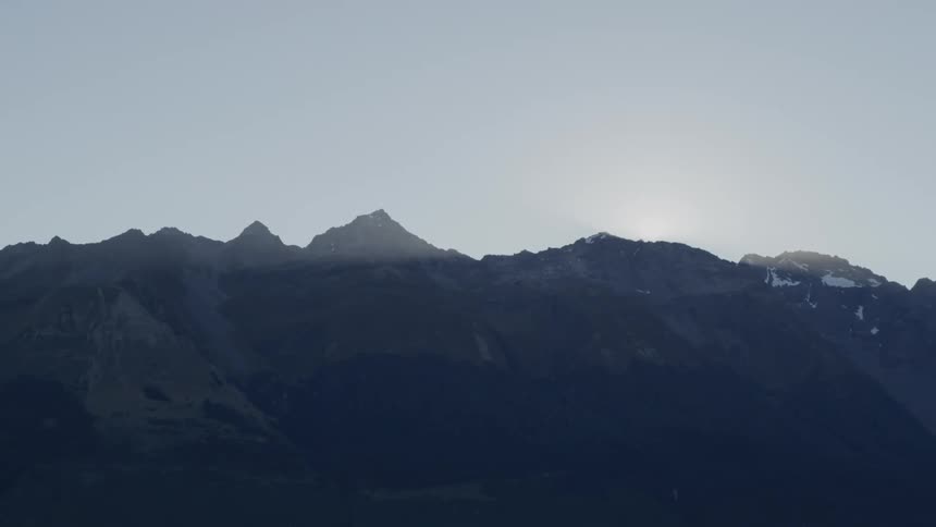 Graphic mountain peaks with a sliver of sun