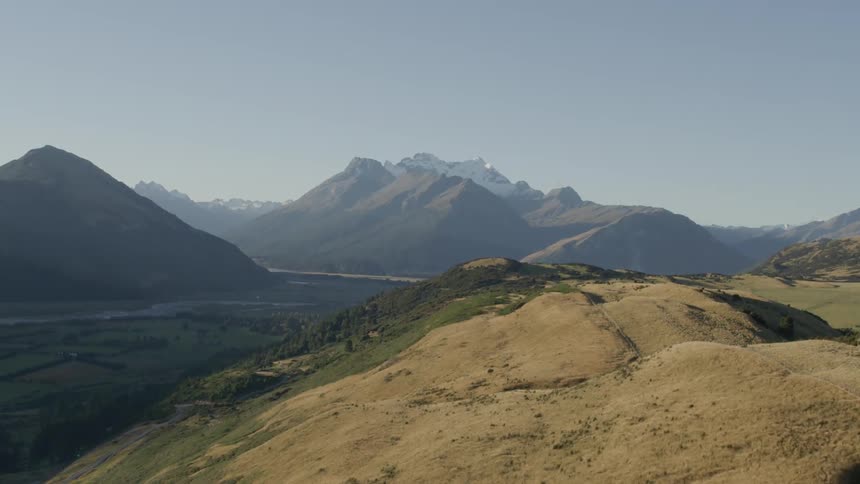 Low hills in a mountain valley near a river and plains