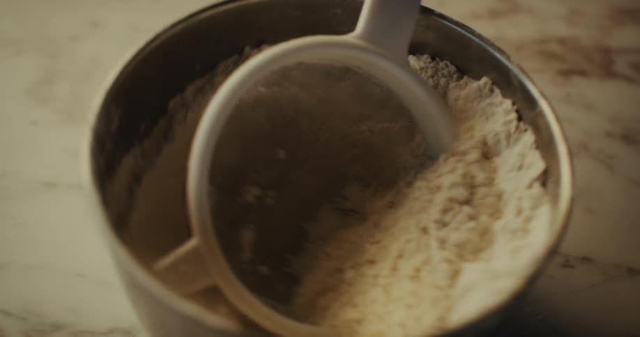 Extreme close up on a small pot with powder and sieve