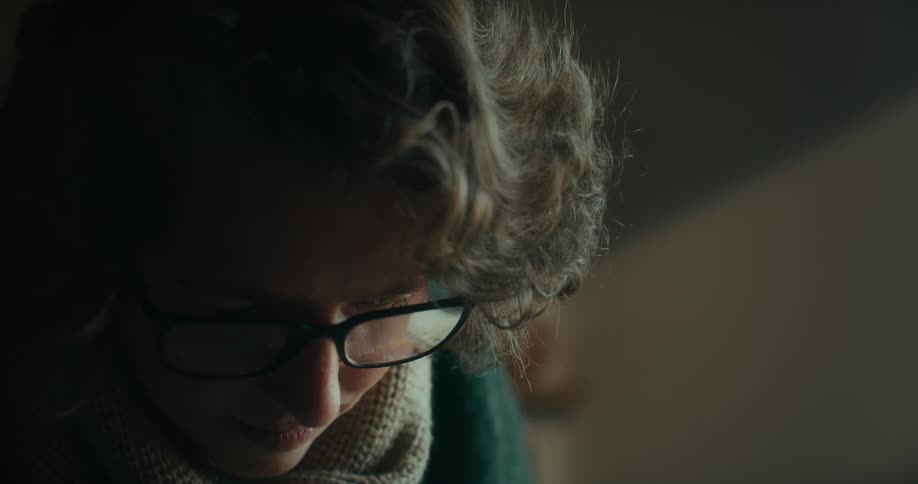 A woman is looking down at something