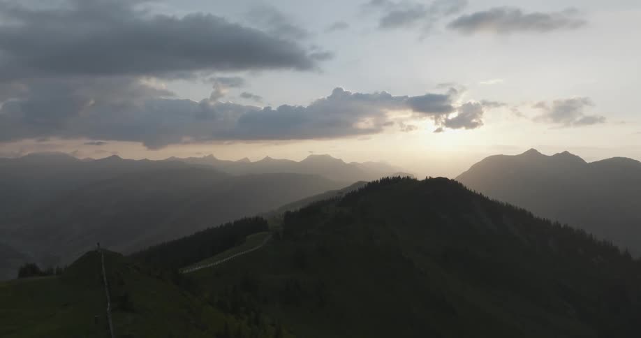 A large home is at the top of one of the mountains