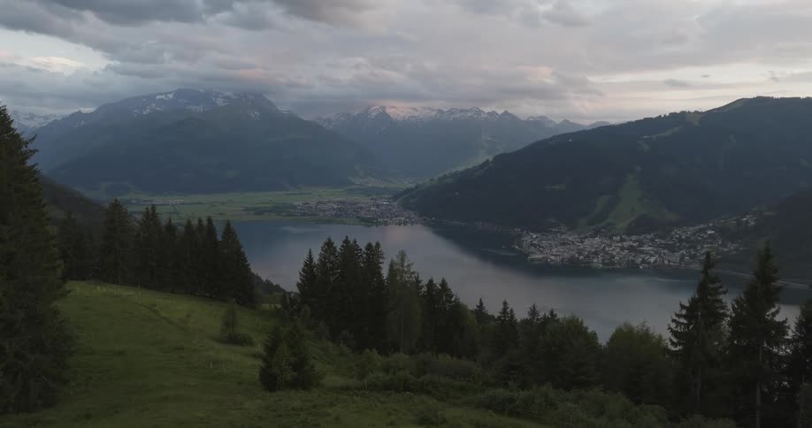 Aerial of a housing village next to a mountain lake on a cloudy evening