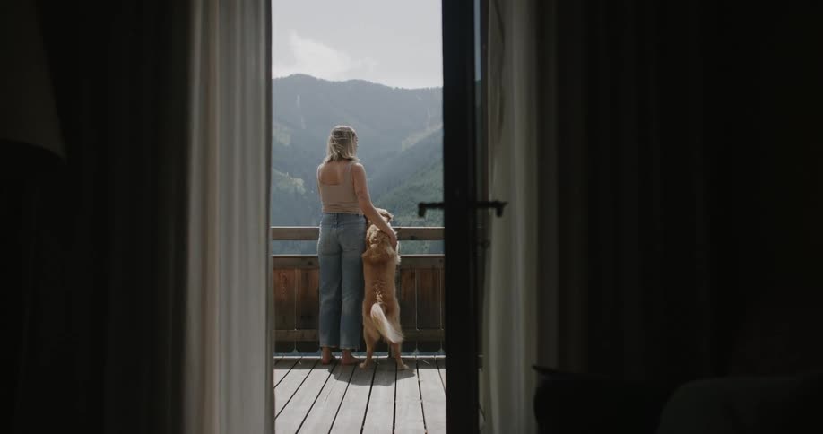 Golden retriever receiving affection from a blonde woman with her by her side