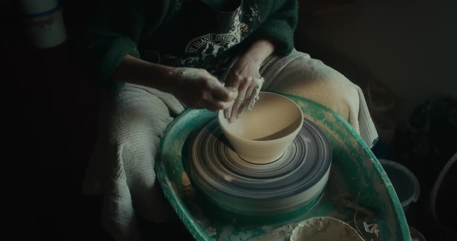 Womans hands making a clay vase