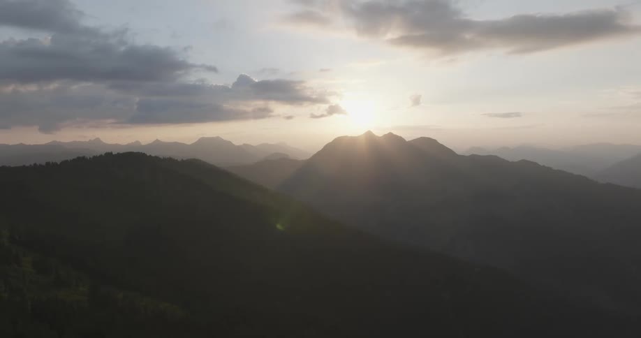 Mountainous landscape with a sunset on the horizon