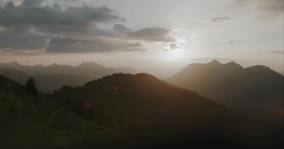 Sun setting amidst mountain ranges