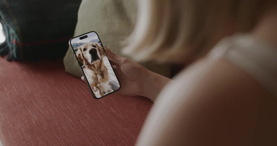 Woman talking in selfie with a golden retriever dog