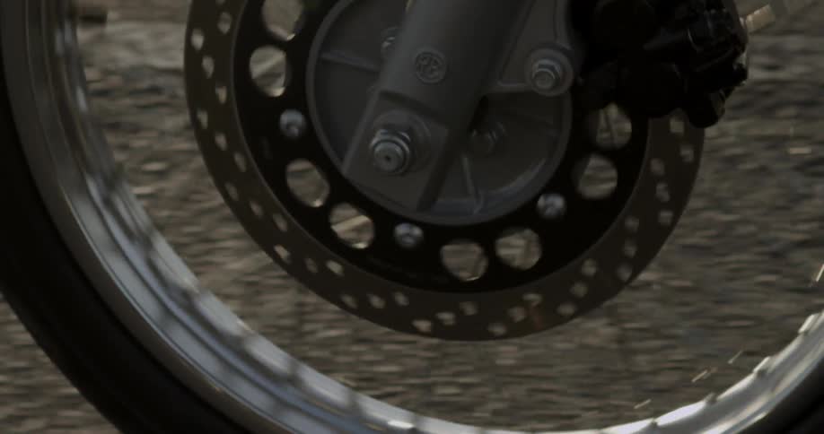 A bike tire spinning over the street