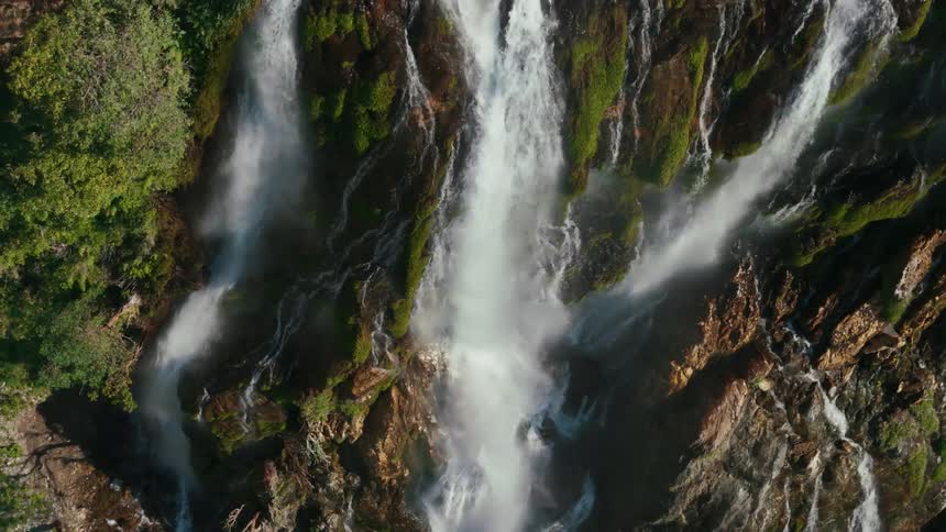 View from above of a waterfall with freefalling mosses