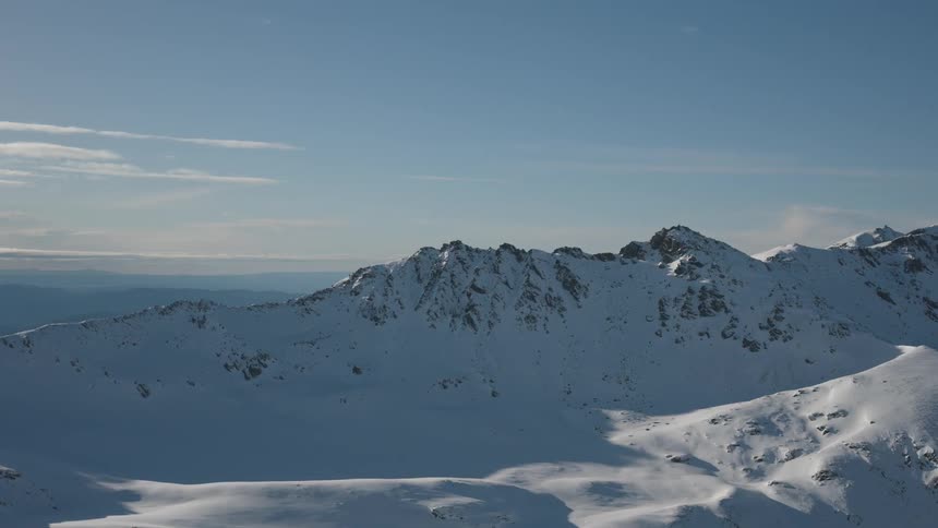 A mountain of rocks covered in snow in an allwhite environment