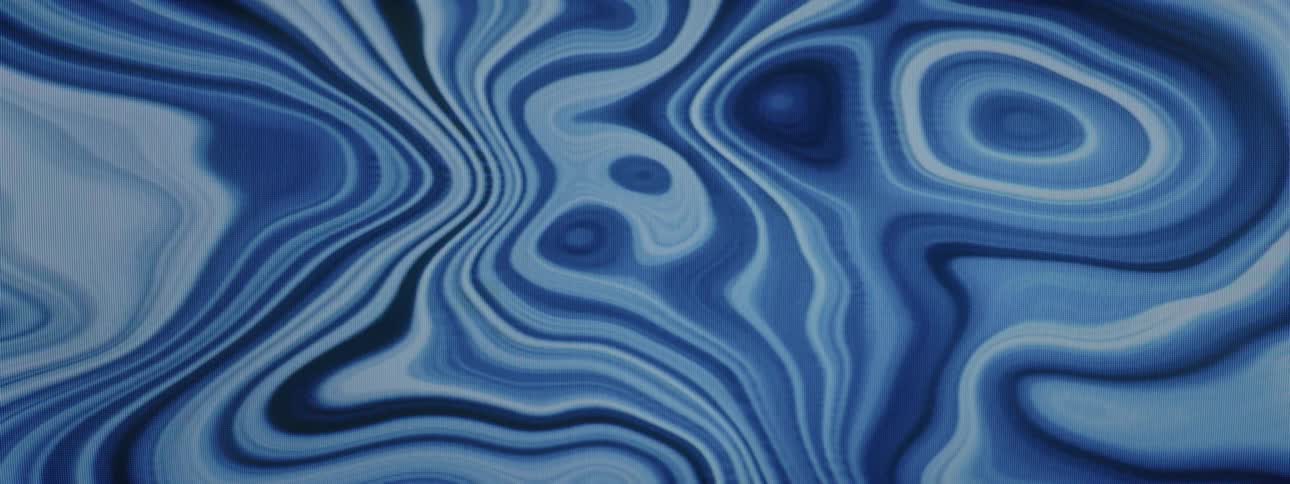 Varying shades of blue liquid merge with each other before moving around again