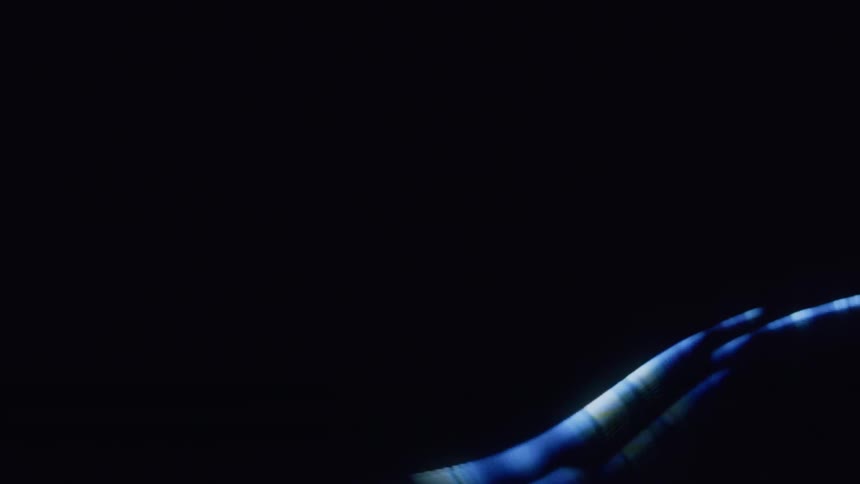Waves of blue light move around against a black background
