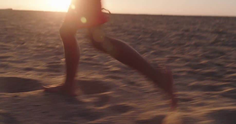 A boy is running on the sand