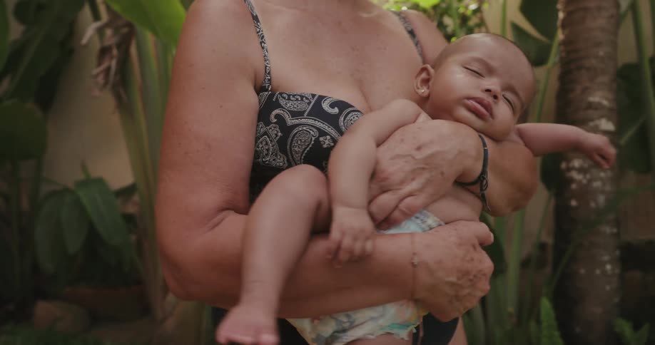 A baby is being rocked outside