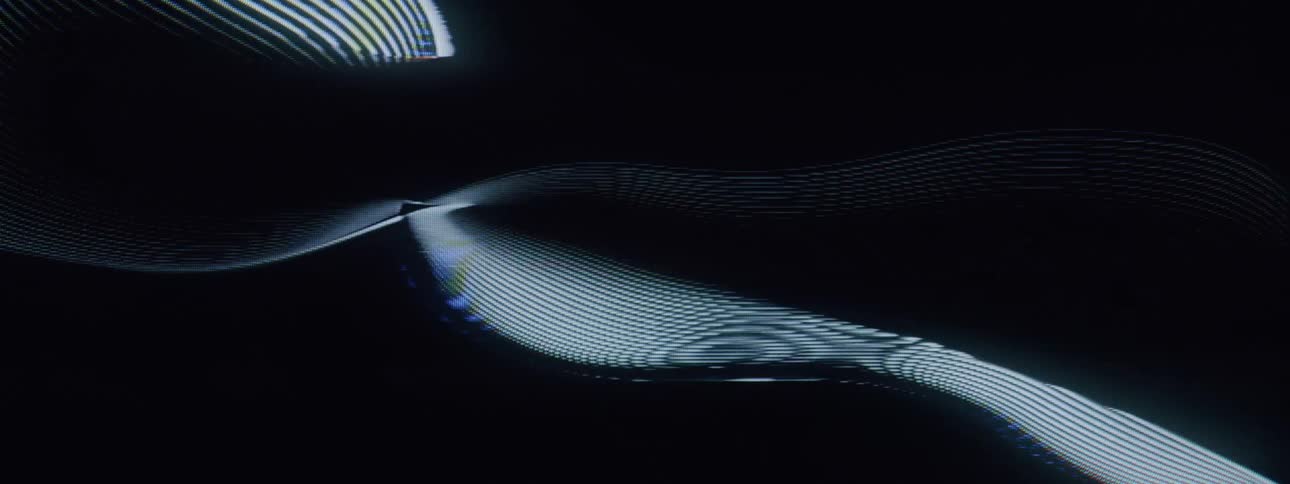 A dynamic wave like light show against a black background