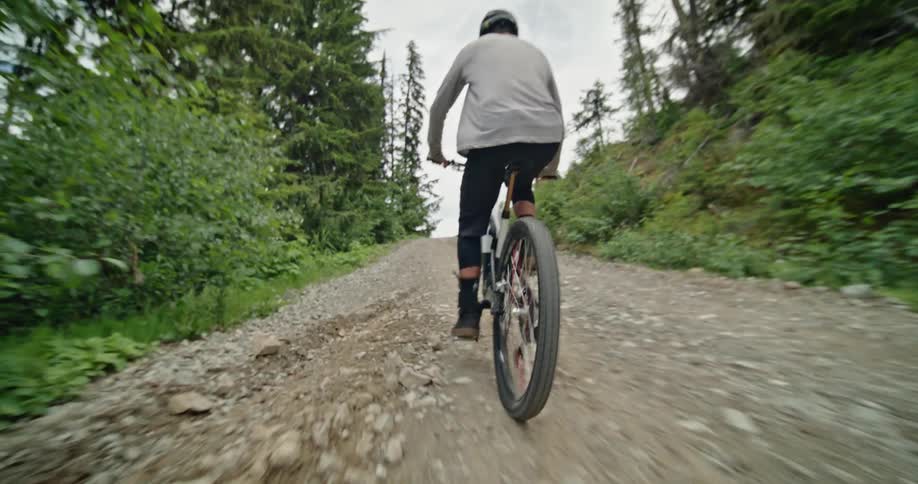 A man is riding his mountain bike uphill