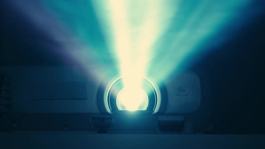 Digital projector casting light and exposing smoke in front of it