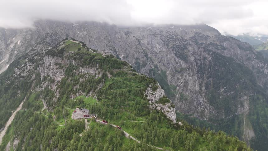 Aerial view of a mountain valley with winding roads on a cloudy day