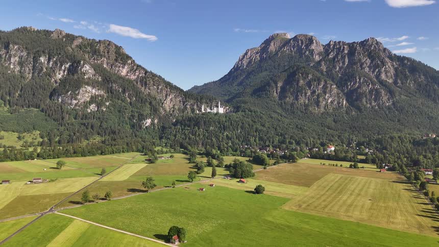 Aerial scenery of agricultural fields and large mountains in the background
