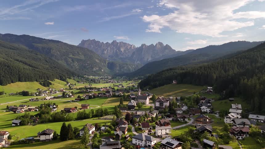 Aerial panorama of a village nestled in a green valley