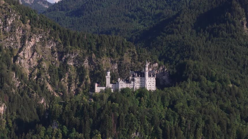 An aerial view of a large castle in a mountain