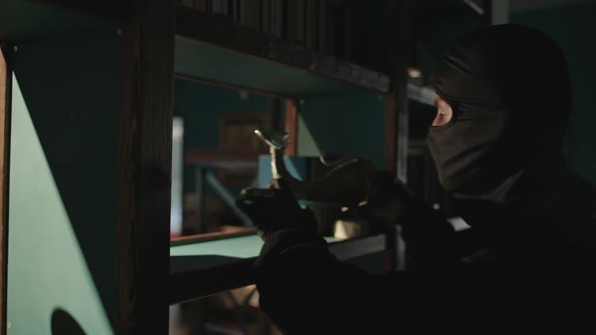 Thief stealing a ceramic object from a shelf