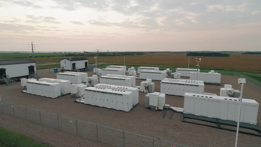 A large battery backup power plant in the middle of a farm field