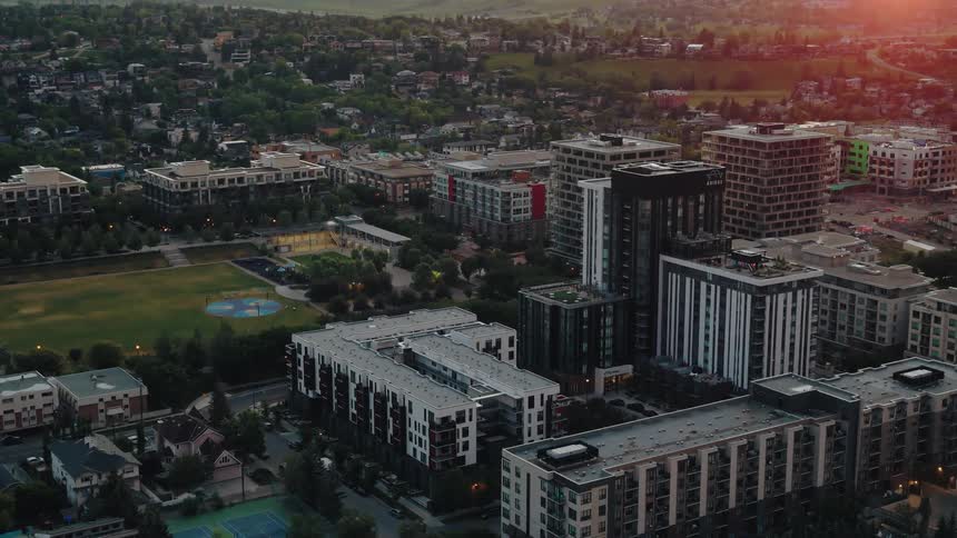 A complex of tall city buildings surrounded by suburbs