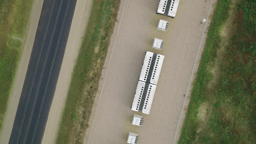 Top view of a battery power station near a road during summer