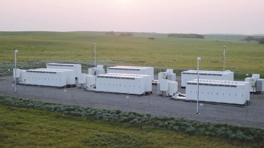 Aerial view of power generators in a field one morning