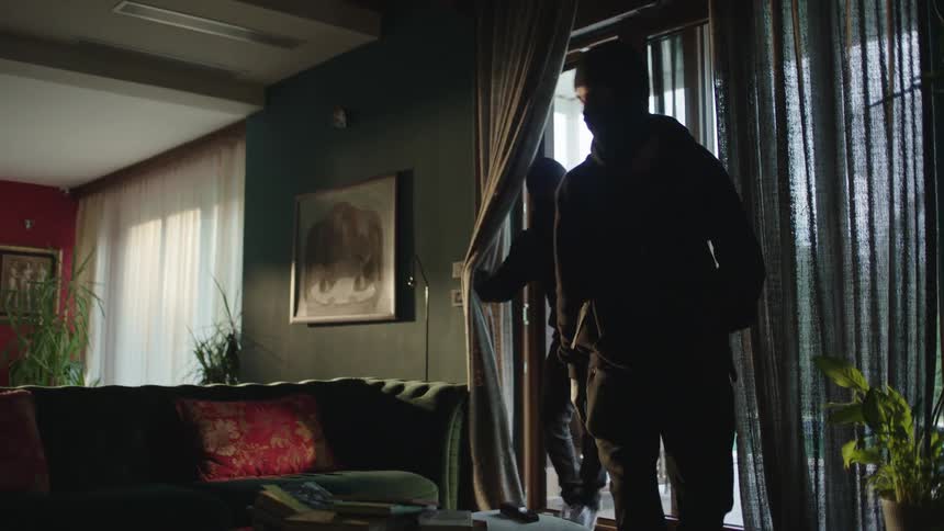 Two thieves breaking into a house