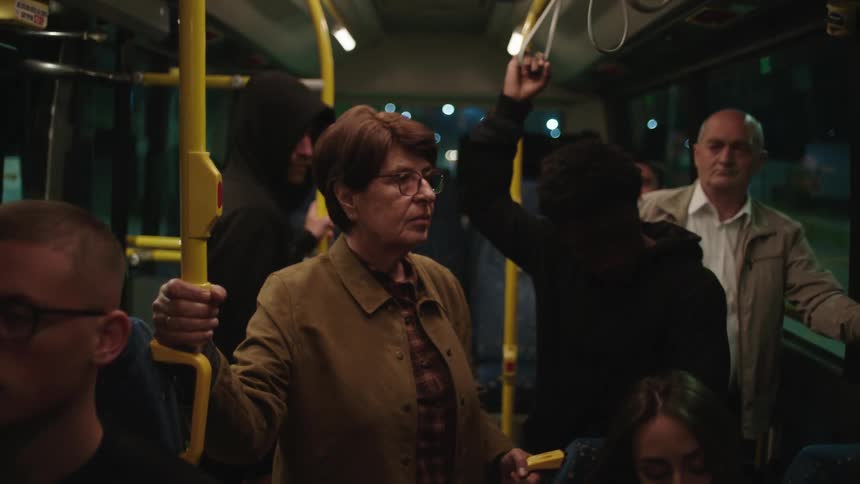 Two suspicious men entering a public bus with other passengers