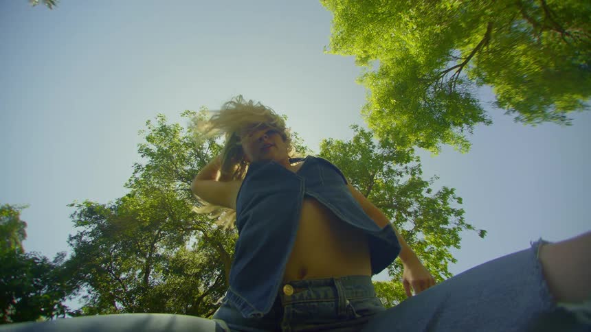 Blonde woman dancing in a natural environment