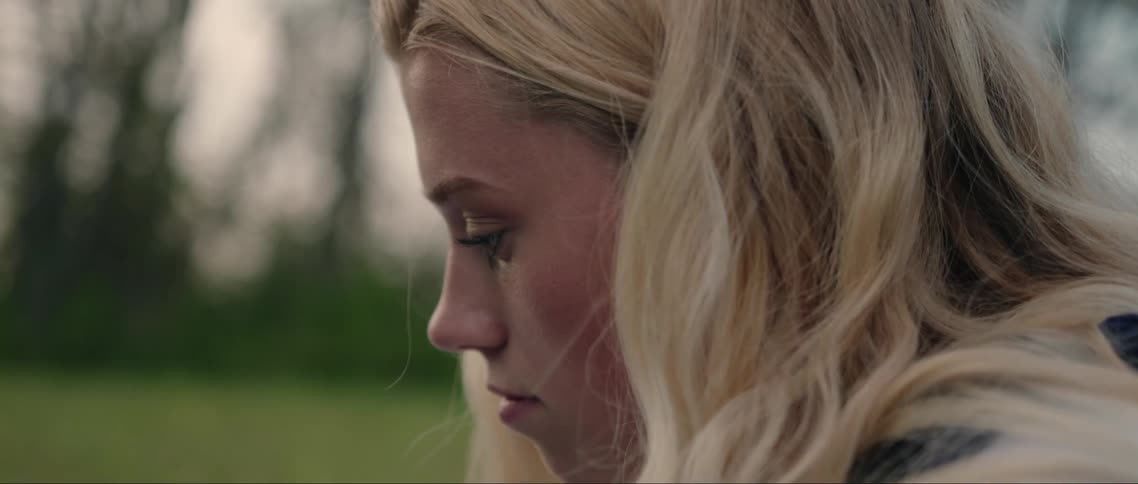A woman looks sad outside