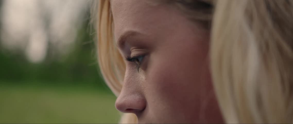 A woman is looking down outside