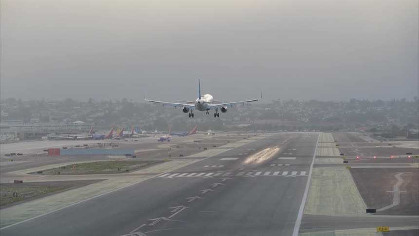 A plane flies down to the runway