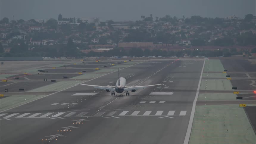A large plane lands on the runway