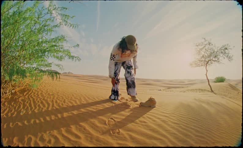 Man in a desert environment wearing a boot