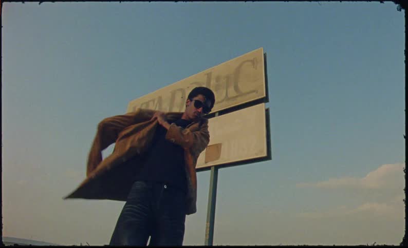 Young man rocking a brown coat and wearing