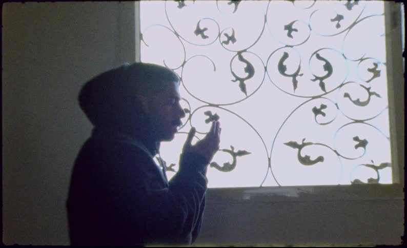 Man with eyes closed and hands close to his face praying