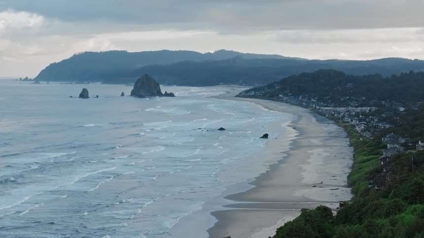 Aerial view of a coastal town with prominent rocks formation near the coast
