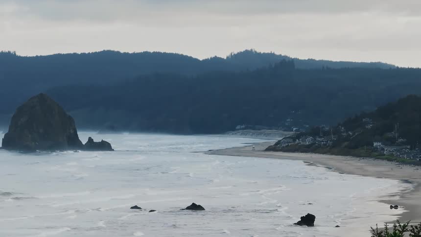 Aerial view of a coastal town with prominent rocks formation near the coast