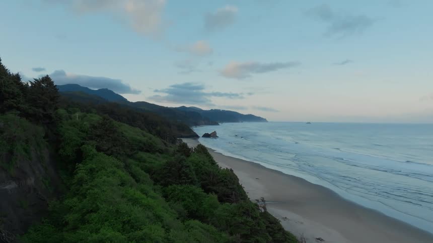 Aerial view of a coastal scene with gentle waves and a sandy beach