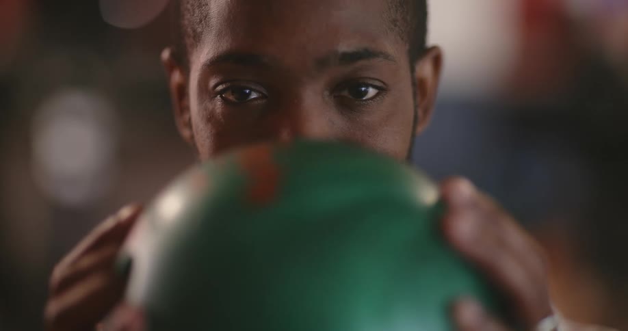 A man is holding a bowling ball