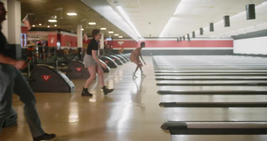 People indoors playing bowling